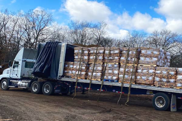 Image of a truck loaded with packs of firewood on pallets
