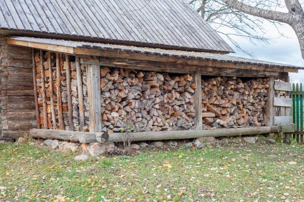 An extensive firewood supply under an awning