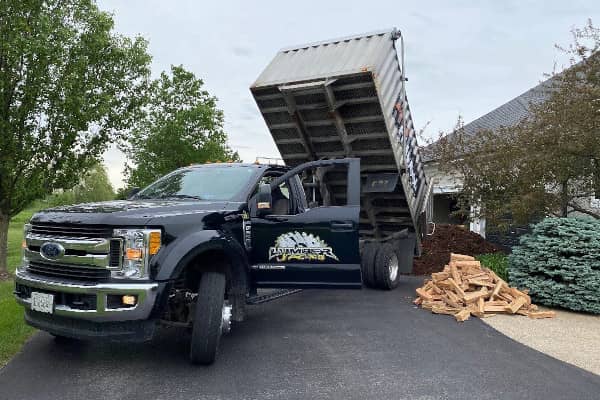 Truck delivering kiln-dried firewood and mulch to an Arlington Heights home