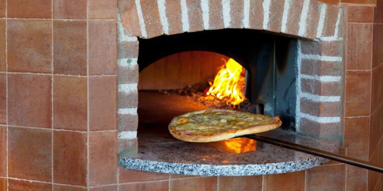 A pizza sliding into a pizza oven