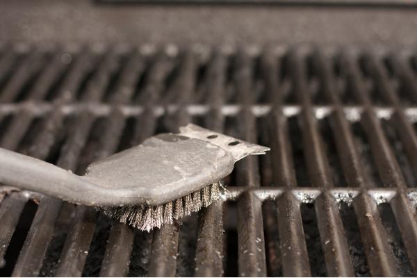 An industrial brush upon a seasoned grill