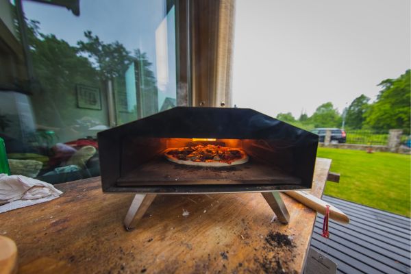 Cooking wood burns in a portable pizza oven