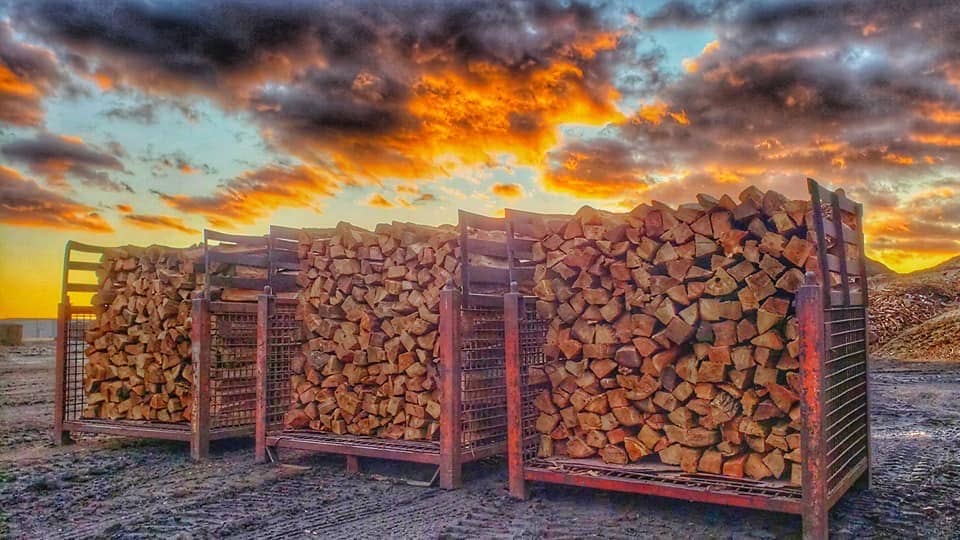 Kiln-dried firewood in front of a vivid sunset