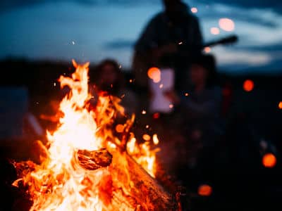A picture of firewood burning on the beach
