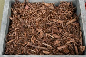 Closeup photo of a bin of bark mulch.