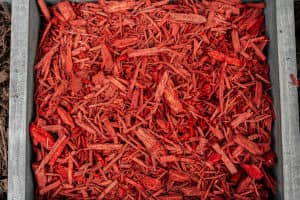 Closeup photo of a bin of red mulch.